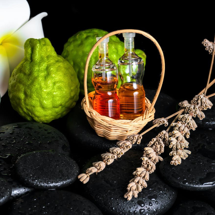 Aromatic spa concept of bottles essential oil, bergamot fruits,