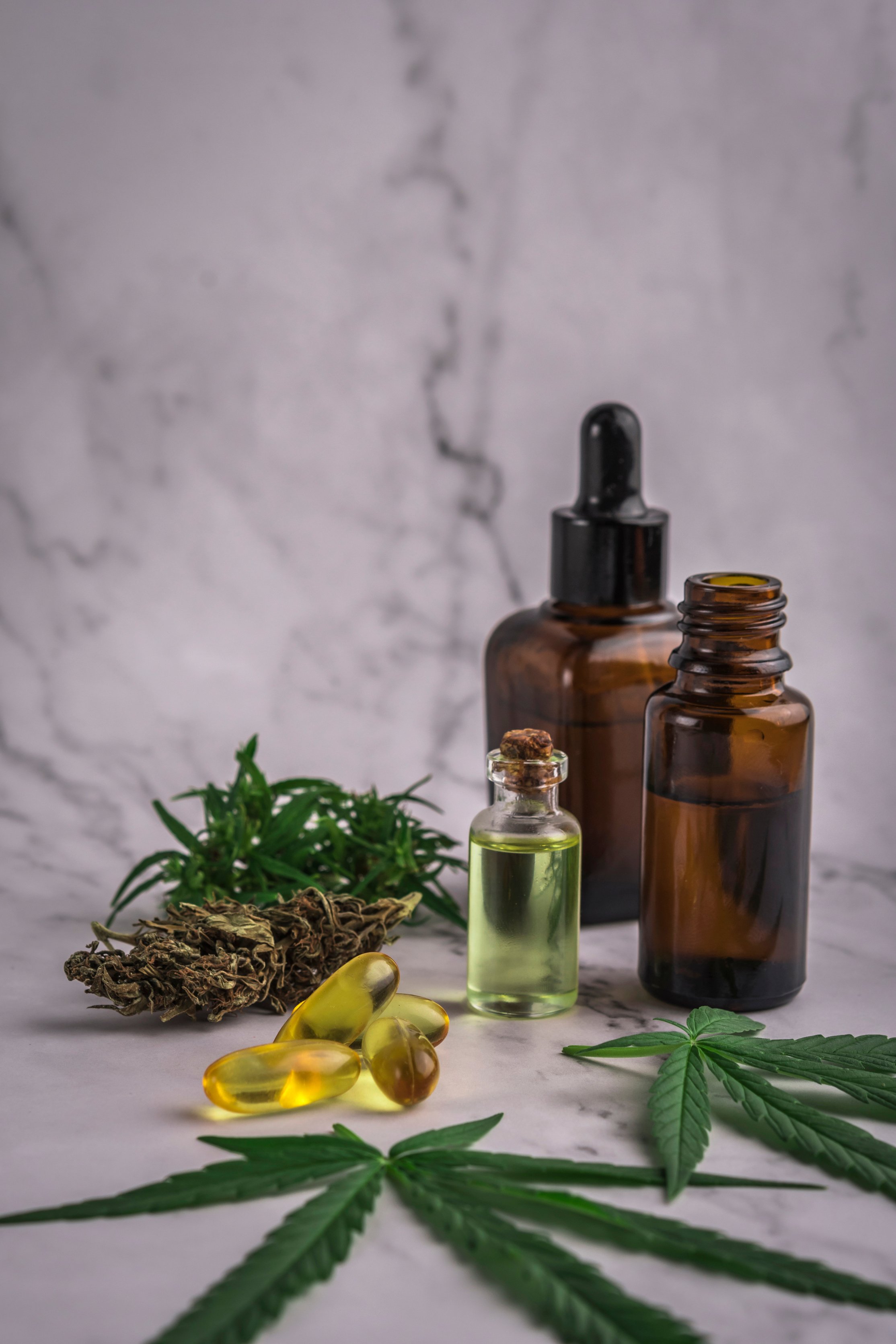 Assorted cannabis products, pills and cbd oil over medical prescription sheet - medical marijuana concept.